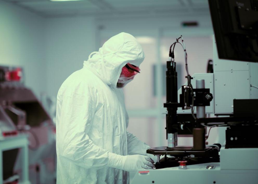 Gowned researcher fabricating device in KU Nanofabrication Facility